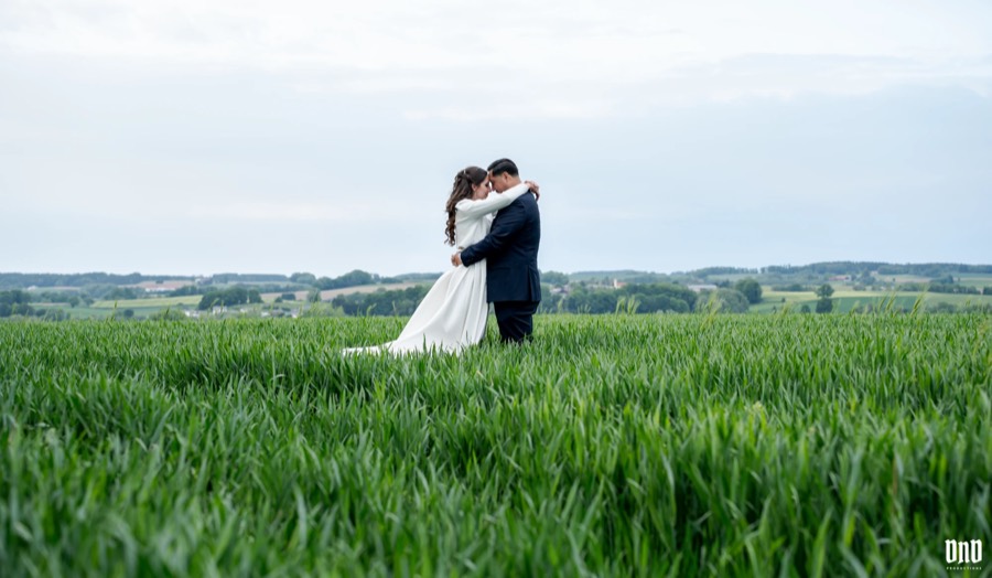 Newlyweds embracing in a field